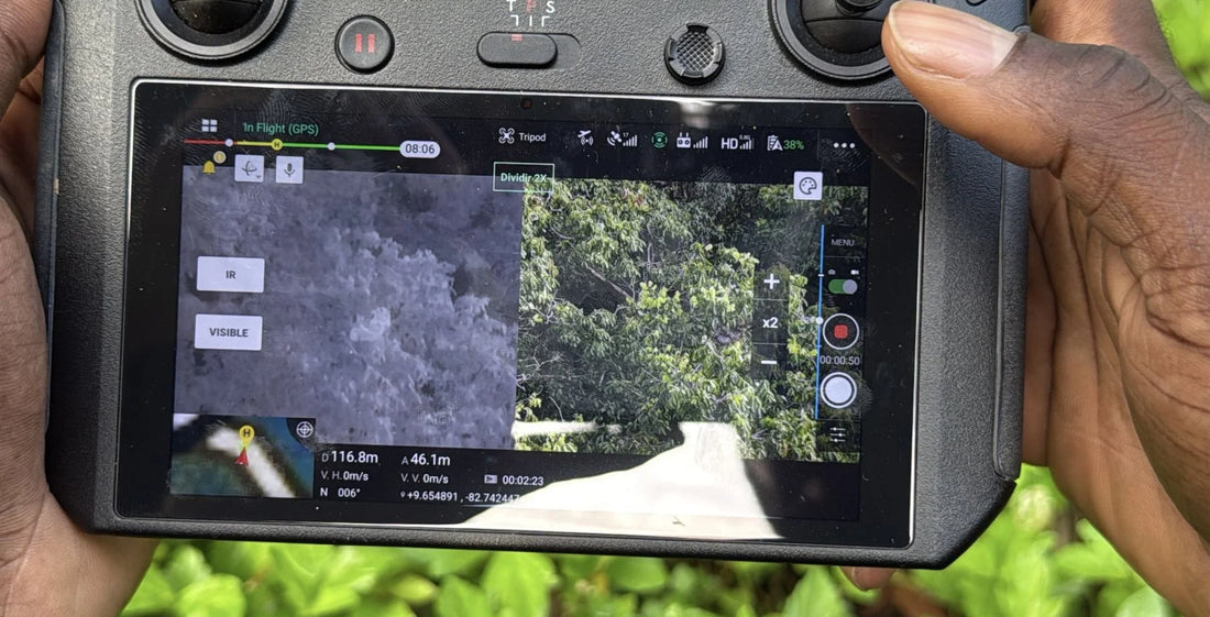 Drone controller showing thermal and visible camera views of rainforest canopy during sloth field research